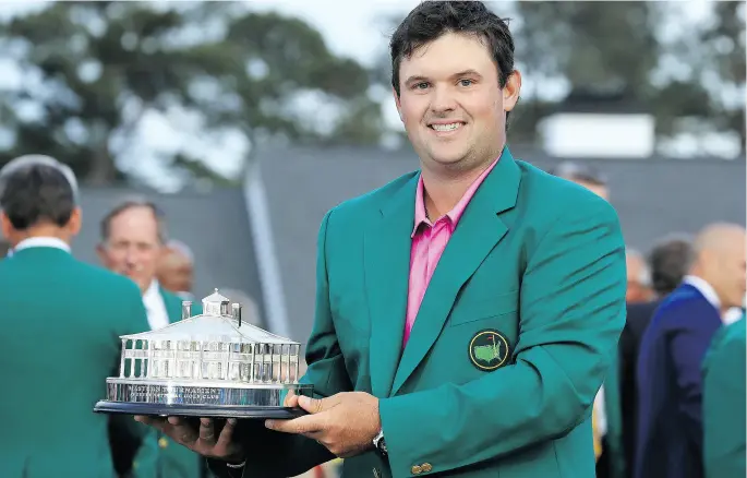  ?? DAVID CANNON / GETTY IMAGES ?? Patrick Reed celebrates with his trophy during the green jacket ceremony after winning the 2018 Masters by one stroke on Sunday in Augusta, Ga.