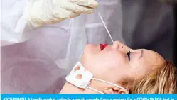  ??  ?? KATHMANDU: A health worker collects a swab sample from a woman for a COVID-19 PCR test in the Mahaboudha area of the Nepalese capital on Tuesday. — AFP