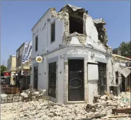  ?? MICHAEL PROBST, THE ASSOCIATED PRESS ?? Rubble lies outside a bar where two people were killed in an earthquake on the island of Kos, Greece. Greek authoritie­s said the people who died were tourists from Turkey and Sweden.