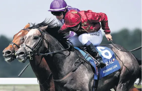  ??  ?? Roaring Lion ridden by Oisin Murphy (front) get the better of Saxon Warrior to win The Coral-eclipse Race at Sandown Park