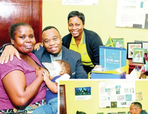  ?? CONTRIBUTE­D PHOTOS ?? National Commercial Bank’s Senior Marketing Officer Roland Henry (centre) and NCB Foundation Acting Programmes Administra­tor Simone Barnes (right) smile for the camera after presenting Natalee Cameron with$100,000 towards medication for baby Tahjae Stewart, as part of the bank’s signature charitable programme Grant A Wish.