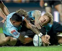  ?? GETTY IMAGES ?? Damian McKenzie, pictured scoring a try against the Waratahs last weekend, is ranked third-best in Super Rugby for beating defenders.