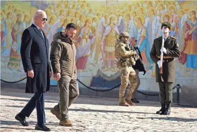  ?? EVAN VUCCI/AP ?? U.S. President Joe Biden, left, walks with Ukrainian President Volodymyr Zelenskyy at St. Michaels Golden-Domed Cathedral during an unannounce­d visit, in Kyiv, Ukraine, on Monday.