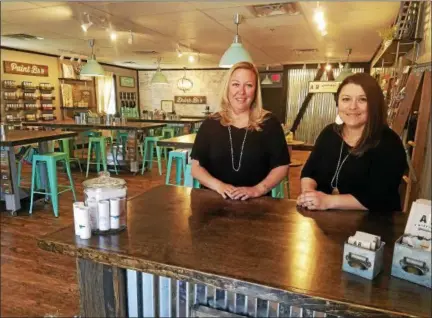  ?? DONNA ROVINS — DIGITAL FIRST MEDIA ?? AR Workshop is a DIY studio at 1810 Swamp Pike in New Hanover where customers can make home decor items from wood or canvas. Shown here are owners Kelly Elliott, left, and Michelle Shilling. The studio officially opens May 19 with an open house from 6 to 9 p.m.