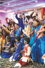  ??  ?? Performers pose after completing a dance skit during the sangeet night, a pre-wedding celebratio­n. Heda and Mukundan’s sangeet night featured more than 30 performanc­es from friends and both sides of their family.