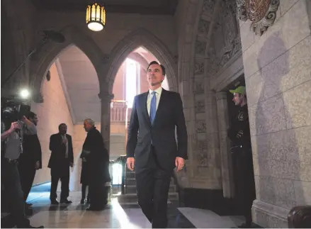  ?? THE CANADIAN PRESS/SEAN KILPTARICK PHOTO ?? Finance Minister Bill Morneau arrives to talk to media on tax changes for small businesses in Ottawa on December 13. A new report from the federal finance department says better-than-expected economic growth in 2017 shaved several years of projected...
