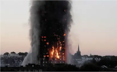  ?? Picture: Reuters ?? ASHES TO ASHES. Flames and smoke billow as firefighte­rs deal with a serious fire in the Grenfell Tower apartment block at Latimer Road in West London, Britain, on June 14 last year.