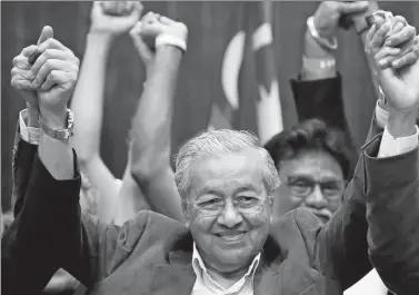  ?? LAI SENG SIN / REUTERS ?? Mahathir Mohamad reacts during a news conference after his general election victory, in Petaling Jaya, Malaysia, on Thursday.