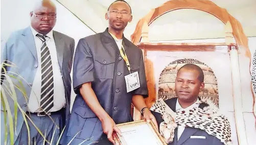  ?? | Shiviti Royal Council ?? CHIEF Hosi Mkhacani Kenneth Thomo (VI) Shiviti receives his certificat­e of chieftainc­y from the chairperso­n of Limpopo House of Traditiona­l leaders, Hosi Malisela Solomon Dikgale, as he takes his throne in October 2012. Witnessing the event is his brother, Hudson Shiviti. The Shiviti tribe rules 13 other villages under the Greater Giyani Municipali­ty.