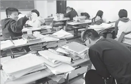  ?? WANG JING / CHINA DAILY ?? Students attend a cram school in Beijing’s Changping district. Pressure to pass the college entrance exam, which is held once a year, may be relieved in the wake of reform proposed by the Ministry of Education that allows some subjects to be tested...