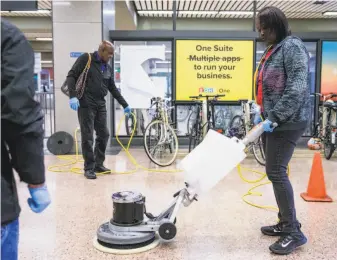  ?? Jessica Christian / The Chronicle ?? BART service worker Ebony Daniels uses a power cleaner in a training session at Lake Merritt Station in Oakland. “They should do this type of class for other custodial jobs,” she says.