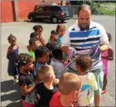  ?? RECORD FILE PHOTO ?? Troy Boys and Girls Club Executive Director Patrick Doyle hands out medals to a group of young kids after a club competitio­n in August 2016.