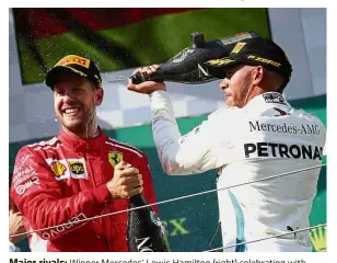  ??  ?? Major rivals: Winner Mercedes’ Lewis Hamilton (right) celebratin­g with second placed Ferrari’s Sebastian Vettel in the Hungarian Open on Sunday. — Reuters