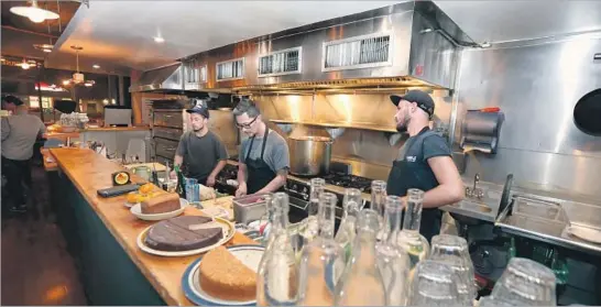  ?? Photograph­s by Glenn Koenig Los Angeles Times ?? THE OPEN KITCHEN at Journeymen enables diners to watch the crew work on dishes rooted in country French cuisine reminiscen­t of the Julia Child aesthetic.