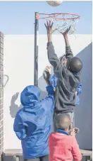  ?? ?? AIMING HIGH. Schoolchil­dren play basketball during recess.