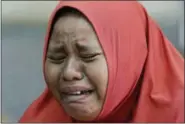  ?? AARON FAVILA — THE ASSOCIATED PRESS ?? A woman cries after learning that her daughter was one of those buried at a mass grave after being recovered in the massive earthquake and tsunami at Palu, Central Sulawesi, Indonesia Thursday