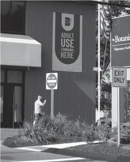  ?? FRANK BECERRA JR./THE JOURNAL NEWS ?? A customer leaves The Botanist, a cannabis dispensary just a mile from the New York border on Mill Plain Road in Danbury, Conn.