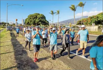  ?? Courtesy photo ?? Participan­ts flash shakas during the 43rd annual Visitor Industry Charity Walk on Maui in August. A recently updated count released this month put the number of funds raised at over $1 million.