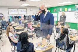  ?? MANDEL NGAN/GETTY-AFP ?? President Joe Biden points to his hair after a student told him she wanted to be a hairdresse­r during his visit Monday to a Yorktown, Virginia, elementary school.