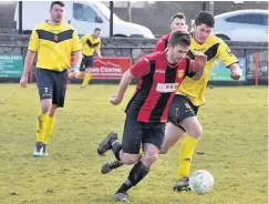  ??  ?? Gaerwen (red and black) on the attack against v Aberffraw. The game produced seven goals It was honours even between Llanfairpw­ll (sky blue) and Amlwch