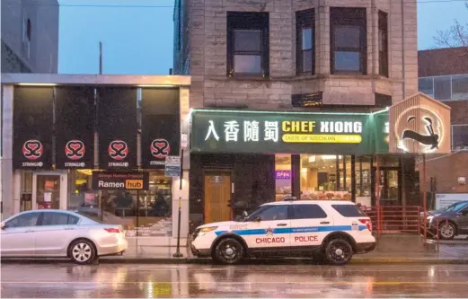  ?? TYLER LARIVIERE/SUN-TIMES ?? A Chicago police vehicle sits in the Chinatown neighborho­od Wednesday in response to the shootings that happened in Atlanta on Tuesday.