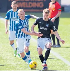  ??  ?? Harry Cochrane takes on Killie’s Mitch Pinnock.