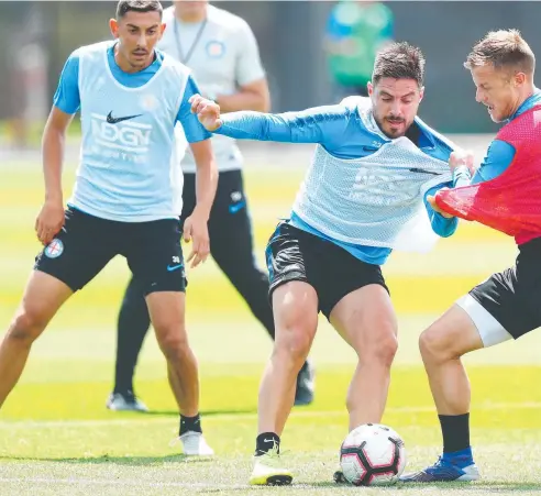  ?? Picture: GETTY ?? FOOTWORK: Glory’s Bruno Fornaroli fends off a tackle from Melbourne City’s Scott Jamieson in a training session.