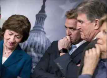  ?? J. SCOTT APPLEWHITE - THE ASSOCIATED PRESS ?? From left, Sen. Susan Collins, R-Maine, Sen. Jeff Flake, R-Ariz., Sen. Joe Manchin, D-W. Va., and Sen. Jeanne Shaheen, D-N.H., finish a news conference on the bipartisan immigratio­n deal they reached during a news conference at the Capitol in...