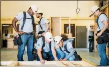  ?? ASSOCIATED PRESS ?? This photo provided by The Home Depot shows students training at the The Home Depot Foundation and HBI’s Ft. Stewart Program on a job site in Ft. Stewart, Ga.