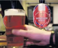  ?? PHOTO: REUTERS/ ?? Cheers . . . A drinker holds a pint of Harry and Meghan’s Windsor Knot pale ale in a pub in Eton.