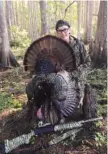  ?? PHOTO CONTRIBUTE­D BY LARRY CASE ?? Jack Ellis shows off a gobbler he shot in Florida. You’ll probably have to alter your typical plan when taking a young turkey hunter into the woods, but the effort is worth it, writes outdoors columnist Larry Case.