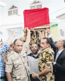  ??  ?? The coffin of a soldier, killed in the attack on an outpost in the Sinai Peninsula, is carried during a funeral in the 10th of Ramadan city, about 60 kilometres north of Cairo, on Saturday.