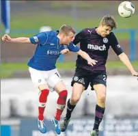  ??  ?? Stephen O’Donnell clears under pressure from Cowden’s Kyle Miller (left).