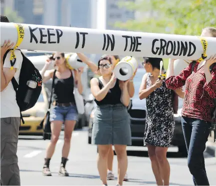  ?? ALLEN McINNIS ?? Demonstrat­ors stage a protest along René Lévesque Blvd. on Aug. 11 against TransCanad­a’s Energy East pipeline. As public hearings on the project open Monday, participan­ts are wary of the process after reports questioned the impartiali­ty of the National Energy Board.