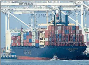  ?? A U.S. Coast Guard vessel AP ?? patrols nearby as the container ship Horizon Enterprise is unloaded earlier this month at the Port of Oakland, Calif. Imports surged in the third quarter as companies sought to get ahead of the increased tariffs, while exports fell as more U.S. goods face retaliator­y tariffs abroad.