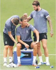  ?? — Reuters photo ?? Real Madrid’s Cristiano Ronaldo sits beside Sergio Ramos (right) and Nacho Fernandez during the training session at open media day.