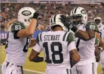  ?? BILL KOSTROUN — THE ASSOCIATED PRESS ?? New York Jets' Chris Gragg ( 87) and Eric Tomlinson ( 83) celebrate with teammate ArDarius Stewart ( 18) after Stewart scored a touchdown during the second half of a preseason NFL football game against the New York Giants on Saturday in East...