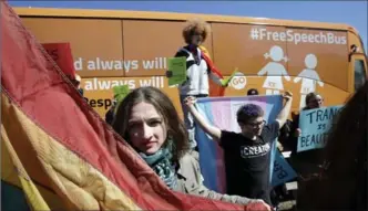  ?? STEVEN SENNE, THE ASSOCIATED PRESS ?? Protesters in support of transgende­r rights hold flags beside the "Free Speech Bus," painted with the words "boys are boys" and "girls are girls," in the Harvard Square neighbourh­ood of Cambridge, Mass., Thursday.