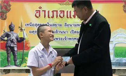  ?? Photograph: Chiang Rai Public Relations Office Handout/EPA ?? Mongkol Boonpiam receives Thai citizen ID card