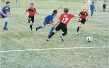  ?? KRIS DUBE SPECIAL TO THE WELLAND TRIBUNE ?? Gavin Beck and Jason Christie from the Welland Wizards team go up against players from Brampton at Saturday’s soccer festival.