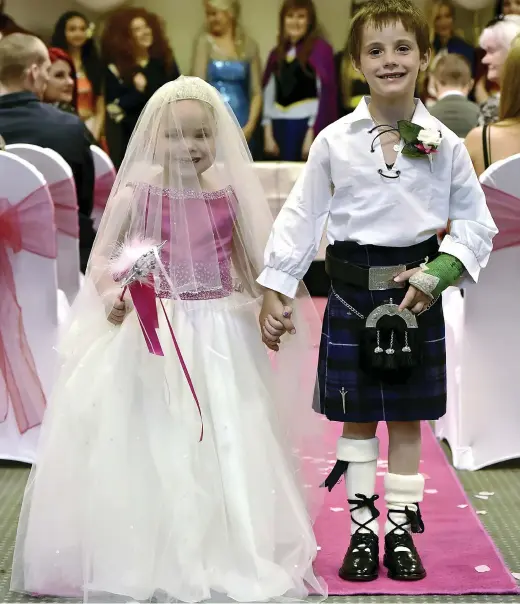  ??  ?? Dream comes true: Little princess Eileidh Paterson, five, walks down the aisle with best friend Harrison Grier, six