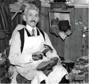  ??  ?? A shoemaker in his workshop in South Kensington, London, c1930