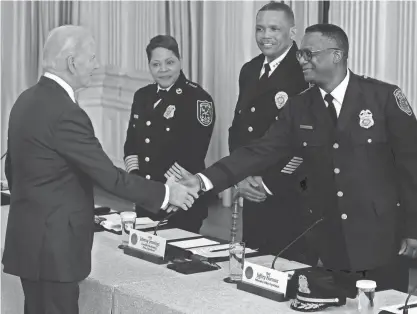  ?? CHIP SOMODEVILL­A / GETTY IMAGES ?? President Joe Biden greets Milwaukee Police Chief Jeffrey Norman before a meeting with Norman and other police chiefs from across the country and members of his administra­tion in the State Dining Room at the White House on Wednesday in Washington. Biden touted achievemen­ts in reducing crime.