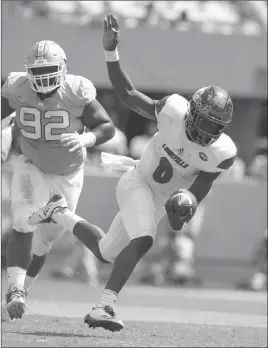  ?? Gerry Broome ?? The Associated Press Louisville quarterbac­k Lamar Jackson, right, can make a serious move on the Heisman provided he can dent No. 3 Clemson’s stifling defense.