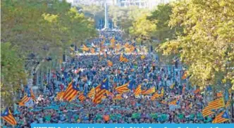  ?? —AFP ?? BARCELONA: People hold pro-independen­ce Catalan Esteladas flags as they gather for a demonstrat­ion yesterday in Barcelona, to support two leaders of Catalan separatist groups, Jordi Sanchez and Jordi Cuixart, who have been detained pending an...