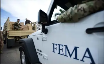  ??  ?? In this 2017 file photo, Department of Homeland Security personnel deliver supplies to Santa Ana community residents in the aftermath of Hurricane Maria in Guayama, Puerto Rico. AP Photo/CArLoS GIuStI