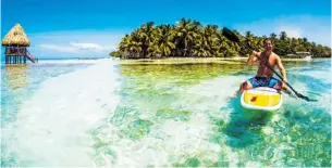  ?? Photos, Sanctuary Belize ?? The crystal-clear waters of the Caribbean are enjoyed by a boogie boarder near the developmen­t.
