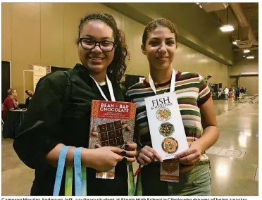  ?? ADDIE BROYLES / AMERICAN-STATESMAN PHOTOS ?? Cameron Morales Anderson, left, a culinary student at Steele High School in Cibolo who dreams of being a pastry chef,pickedou t a copy of “Bean to Bar Chocolate” at the Culinary Arts Career Conference. Her classmate Rime Allam picked a book on fish and...