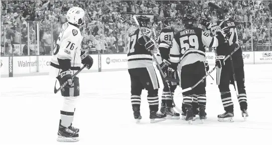  ?? BRUCE BENNETT/GETTY IMAGES ?? Predators defenceman P.K. Subban skates off as the Penguins celebrate a goal by Evgeni Malkin during Game 1 of the Stanley Cup Final Monday in Pittsburgh.