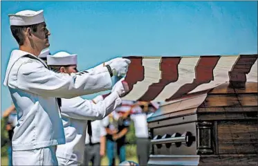  ?? CHRIS ZOELLER/AP ?? U.S. Navy sailors fold the U.S. flag over the casket with the remains of Seaman First Class Leon Arickx in Osage, Iowa.